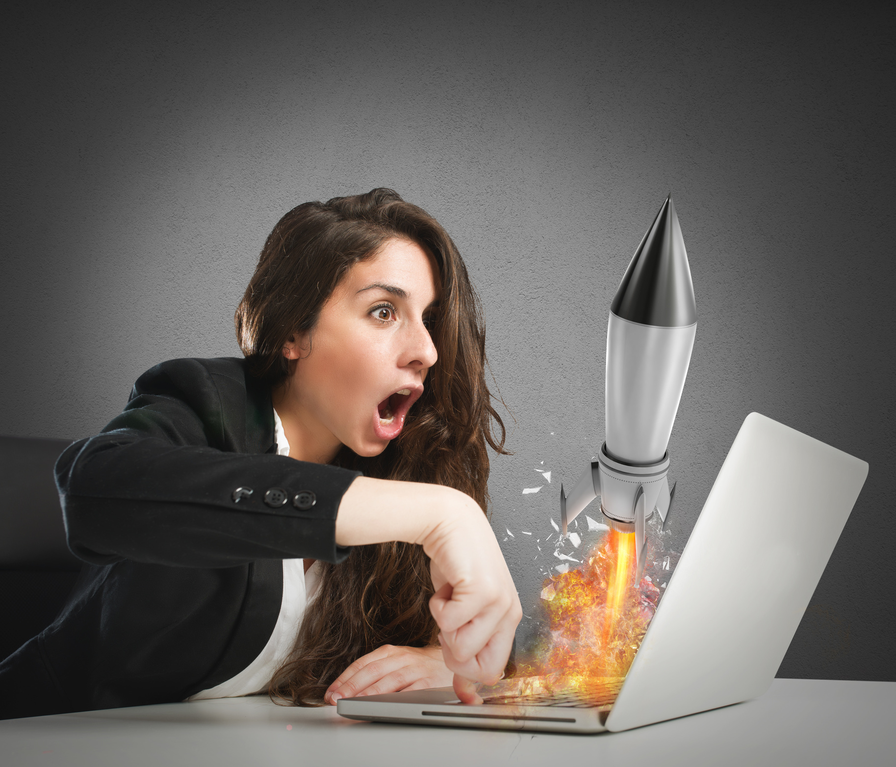 Businesswoman Launches Rocket from a Laptop. Concept of Company Startup